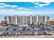 Aerial view of a beachfront condo building with a pool, parking, and stunning ocean views at 18650 Gulf Blvd # 303, Indian Shores, FL 33785