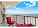 Balcony featuring red chairs and a table overlooking the beach at 18650 Gulf Blvd # 303, Indian Shores, FL 33785