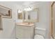 Bright bathroom with a vanity, framed mirror, and shower with glass doors, creating a clean, functional space at 18650 Gulf Blvd # 303, Indian Shores, FL 33785