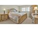 Traditional bedroom featuring a wooden bed frame, neutral walls, and a window with plantation shutters at 18650 Gulf Blvd # 303, Indian Shores, FL 33785