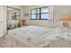 Bright bedroom with a large window, comfortable bed, and dresser, creating a serene and welcoming atmosphere at 18650 Gulf Blvd # 303, Indian Shores, FL 33785