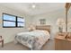 Bright bedroom features a large window, a comfortable bed, and a dresser, offering a relaxing retreat at 18650 Gulf Blvd # 303, Indian Shores, FL 33785