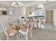 Dining area with a glass table and seating for four, adjacent to the open kitchen at 18650 Gulf Blvd # 303, Indian Shores, FL 33785