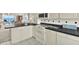 Well-equipped kitchen featuring sleek black countertops and appliances, next to the dining area at 18650 Gulf Blvd # 303, Indian Shores, FL 33785