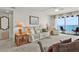 Cozy living room featuring comfortable seating, lamps, and a view of the ocean at 18650 Gulf Blvd # 303, Indian Shores, FL 33785