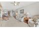Comfortable living room featuring neutral colors and views of the kitchen and dining area at 18650 Gulf Blvd # 303, Indian Shores, FL 33785