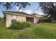 Backyard featuring lush green grass, outdoor dining area, string lights, and a covered patio for relaxation at 20224 Natures Spirit Dr, Tampa, FL 33647