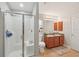 Bathroom features double sinks, a tiled floor, a walk-in shower, and cherry wood cabinets at 20224 Natures Spirit Dr, Tampa, FL 33647