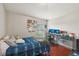 Bedroom featuring desk, two monitors, a window, and a full size bed at 20224 Natures Spirit Dr, Tampa, FL 33647