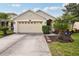 Charming single-Gathering home with a two-car garage, landscaping, and a well-manicured lawn at 20224 Natures Spirit Dr, Tampa, FL 33647