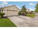 Lovely home featuring a spacious driveway, well-kept landscaping, and an attached two-car garage at 20224 Natures Spirit Dr, Tampa, FL 33647