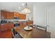 Kitchen area with wood cabinets, stainless steel appliances, and a dining area table and chairs at 20224 Natures Spirit Dr, Tampa, FL 33647