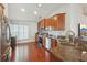 Well lit kitchen features dark countertops, dark cabinetry, and stainless steel appliances with a modern design at 20224 Natures Spirit Dr, Tampa, FL 33647