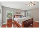 Well lit main bedroom featuring a ceiling fan, nice artwork and two large windows at 20224 Natures Spirit Dr, Tampa, FL 33647