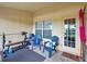 Enclosed patio featuring bench press, free weights, and two blue rocking chairs at 20224 Natures Spirit Dr, Tampa, FL 33647