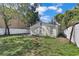 Home's backyard featuring partial fencing and green lawn at 2107 E 93Rd Ave, Tampa, FL 33612