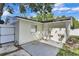 Exterior view of the back of the house and back patio area with a fence at 2107 E 93Rd Ave, Tampa, FL 33612