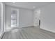 Bedroom featuring modern gray floors, light walls, and a window for natural light at 2107 E 93Rd Ave, Tampa, FL 33612