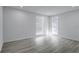 Bright bedroom features updated gray floors, white walls, and natural light at 2107 E 93Rd Ave, Tampa, FL 33612