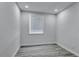 This bedroom has gray floors, light walls and a sunny window at 2107 E 93Rd Ave, Tampa, FL 33612