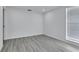 Bedroom with neutral paint, gray vinyl flooring, and a window for natural light at 2107 E 93Rd Ave, Tampa, FL 33612