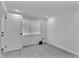 Bright bedroom featuring a window, wood-look floors, and fresh white trim at 2107 E 93Rd Ave, Tampa, FL 33612
