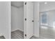 Interior view of closet, featuring open doorway to another room and gray vinyl flooring at 2107 E 93Rd Ave, Tampa, FL 33612