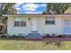 Close-up of a charming home with a well-manicured lawn and a welcoming entrance at 2107 E 93Rd Ave, Tampa, FL 33612