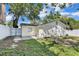Exterior back of home featuring neutral colors, back door and window at 2107 E 93Rd Ave, Tampa, FL 33612