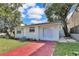 Charming home with brick driveway and manicured landscaping, offering a welcoming exterior at 2107 E 93Rd Ave, Tampa, FL 33612