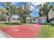 Charming single-story home with a red brick driveway and mature trees at 2107 E 93Rd Ave, Tampa, FL 33612