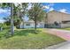 Charming home with a green lawn and a brick driveway, offering a welcoming curb appeal at 2107 E 93Rd Ave, Tampa, FL 33612