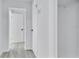 Hallway with neutral paint and multiple doors to access rooms at 2107 E 93Rd Ave, Tampa, FL 33612