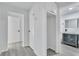 Hallway view leading to bathroom with modern vanity and vessel sink at 2107 E 93Rd Ave, Tampa, FL 33612