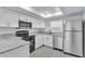 Modern kitchen with stainless steel appliances, stone countertops, and plenty of storage at 2107 E 93Rd Ave, Tampa, FL 33612