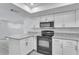 Modern kitchen featuring stainless steel appliances, stone countertops, and ample cabinet space at 2107 E 93Rd Ave, Tampa, FL 33612