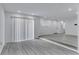 Bright living room with gray flooring, recessed lighting, and sliding glass doors for natural light at 2107 E 93Rd Ave, Tampa, FL 33612