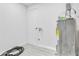 Well-lit utility room with water heater and access door, ample space at 2107 E 93Rd Ave, Tampa, FL 33612