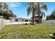 Secluded backyard with a pergola, mature trees, and a well-maintained fence at 2127 Scotland Dr, Clearwater, FL 33763
