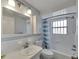 Bathroom with white tiles, a blue and white shower curtain, and vanity with sink at 2127 Scotland Dr, Clearwater, FL 33763