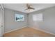Bedroom featuring laminate wood floors, a ceiling fan, and two windows allowing for natural light at 2127 Scotland Dr, Clearwater, FL 33763