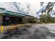 Exterior of the Greenbriar Club, featuring a covered entrance, landscaping and ample parking at 2127 Scotland Dr, Clearwater, FL 33763