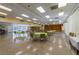 Community room with tables, chairs, stage and natural light for gatherings and activities at 2127 Scotland Dr, Clearwater, FL 33763