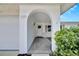 Arched doorway leads to the front door of this home, and shows the address of the home at 2127 Scotland Dr, Clearwater, FL 33763