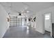 Spacious two-car garage featuring a utility sink, painted walls, and a roll-up door at 2127 Scotland Dr, Clearwater, FL 33763