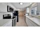 Updated kitchen with white cabinets, stainless steel appliances, and neutral countertops at 2127 Scotland Dr, Clearwater, FL 33763