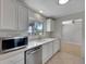 Bright kitchen featuring white cabinetry, stainless steel appliances, and recessed lighting at 2127 Scotland Dr, Clearwater, FL 33763