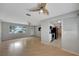 Open concept living room featuring laminate floors, ceiling fans, and views into the kitchen at 2127 Scotland Dr, Clearwater, FL 33763