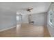 Light and bright living room with wood laminate floors, ceiling fans, and plenty of natural light at 2127 Scotland Dr, Clearwater, FL 33763