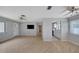 Open concept living room featuring laminate floors, ceiling fans, and views into the kitchen at 2127 Scotland Dr, Clearwater, FL 33763